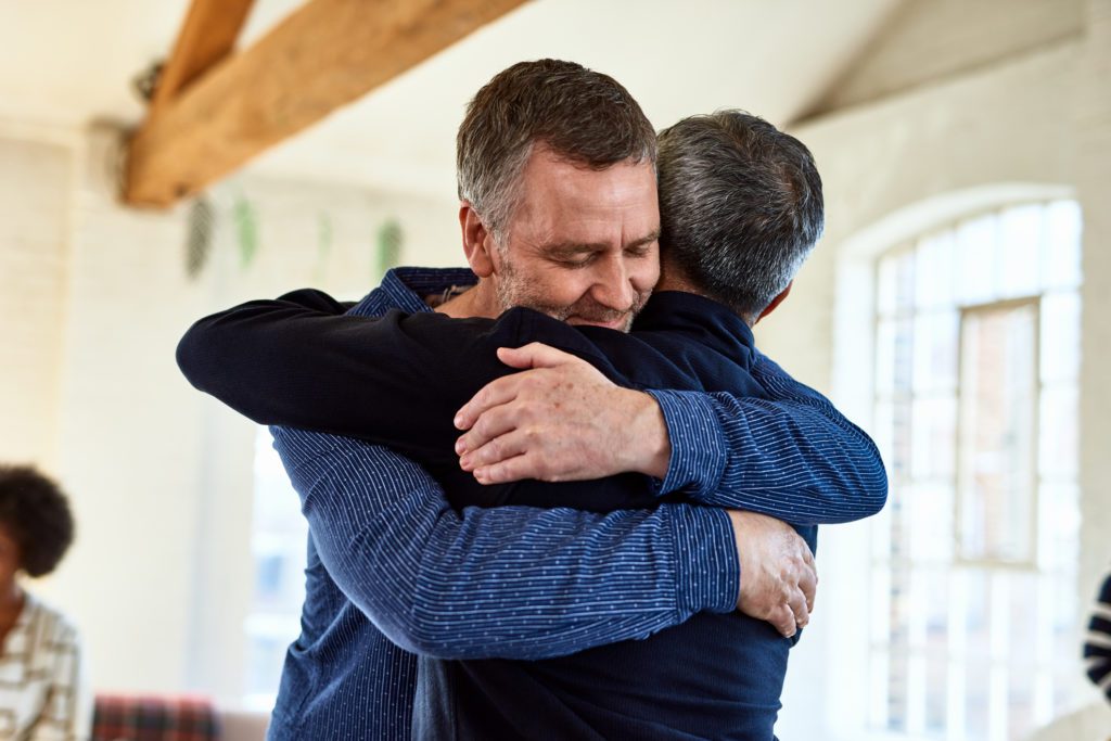 Photo of two person hugging each other