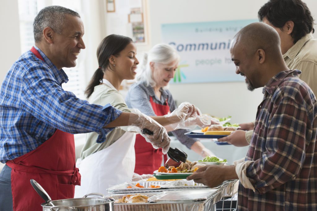 Volunteers serving food at community kitchen